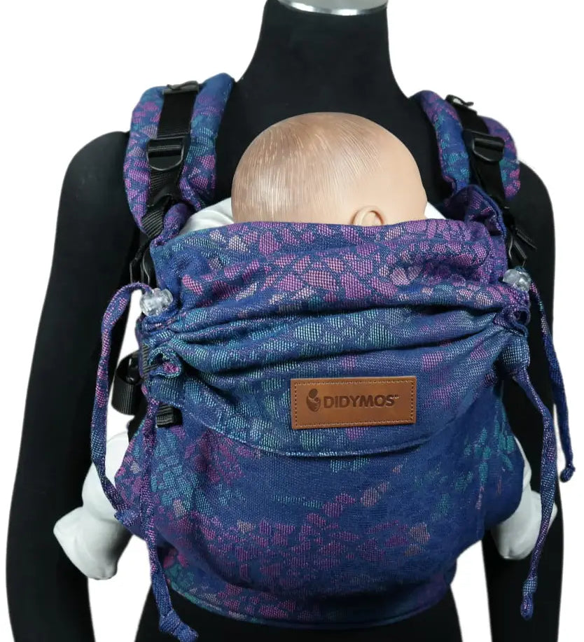 Front of Didymos didyfix carrier in mosaic in the dark design shown on a mannequin. A soft structured full buckle carrier made from cotton