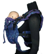 Side of Didymos didyfix carrier in mosaic in the dark design shown on mannequin. A soft structured full buckle carrier made from cotton