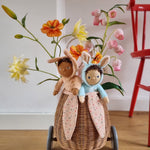 A child happily playing with the Olli Ella Dinky Dinkum Doll Fluffles collection