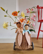 A child happily playing with the Olli Ella Dinky Dinkum Doll Fluffles collection