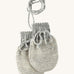 Disana organic merino wool baby mittens in grey and natural colour on a cream background.