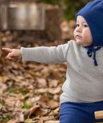 Disana organic merino wool melange jumper in a grey colour worn by a baby 