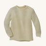 Disana organic merino wool melange jumper in a natural colour on a cream background.