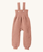 Disana organic merino wool dungarees in rose on a cream background.