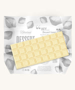 An unwrapped bar of the Divine White Chocolate Lemon Cheesecake Dessert Bar. 