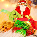 Close up of the Divine milk and dark chocolate coin bags on a white fluffy blanked next to a Lanka Kade Santa figure