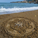 A mandala shape in the sand created using the bamboo tools for the Dr Zigs beach creativity set