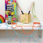 Dr Zigs my loads of bubbles play kit on a white wooden bench with different coloured bubble blowing wands laid out next to the box