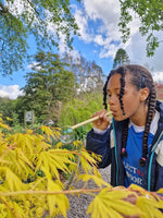 Child using the straw from the Dr Zigs bubble pollinator kit