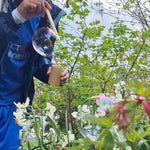 Child using the straw from the Dr Zigs bubble pollinator kit