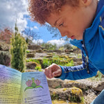 Child looking at the information leaflet from the Dr Zigs bubble pollinator kit