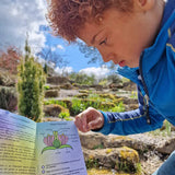 Child looking at the information leaflet from the Dr Zigs bubble pollinator kit