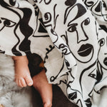A baby asleep in a bassinet