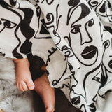 A baby asleep in a bassinet
