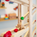 Close up of the Fagus click click marble run toy rolling down a Fagus wooden marble run set