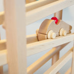 Close up of the Fagus Racer vehicle toy rolling down a Fagus wooden marble run set
