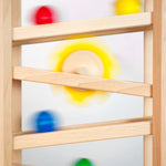 Close up of some Fagus marbles rolling down their handmade wooden marble run set