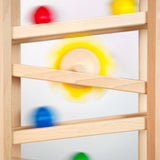 Close up of some Fagus marbles rolling down their handmade wooden marble run set