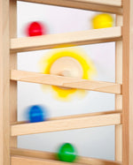 Close up of some Fagus marbles rolling down their handmade wooden marble run set
