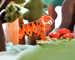 Close up of Bajo Endangered Animals Tiger in a felt toy forest scene