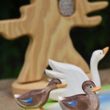 Two Ostheimer wooden ducks placed on a wooden pond scene piece.