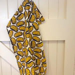 DUNS Sweden organic cotton cheese sandwich tea towel hanging from the back of a white door