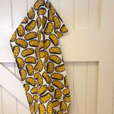 DUNS Sweden organic cotton cheese sandwich tea towel hanging from the back of a white door