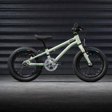 The Early Rider Belter 14" Kids Pedal Bike for 3-5 Years in sage green. The bike is shown in front of black garage doors. Babipur are official stockists of Early Rider. 