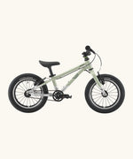 Side of a Early Rider belter 14 inch kids bicycle showing a sage green top half and brushed aluminium bottom half frame
