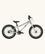 Side of a Early Rider belter 16 inch kids bicycle showing brushed aluminium bottom half frame, belt drive chain and chunky wheels