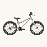 Side of a Early Rider belter 16 inch kids bicycle showing a sage green top half and brushed aluminium bottom half frame