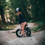 Young girl sat on the Early rider charger balance bike