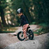 Young girl sat on the Early rider charger balance bike