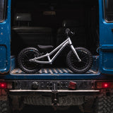 Early rider childrens 12 inch balance bike in the back of a blue 4x4 truck