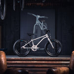 Early Rider children's 16 inch seeker bicycle on a metal work bench in a dark workshop