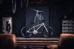 Early Rider children's 16 inch seeker bicycle on a metal work bench in a dark workshop