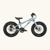 Side of Early Rider kids Seeker 14 inch mountain bike in arctic blue with a brushed aluminium bottom half frame. Features disk brakes and chunky wheels