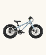 Side of Early Rider kids Seeker 14 inch mountain bike in arctic blue with a brushed aluminium bottom half frame. Features disk brakes and chunky wheels