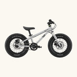 Side of Early Rider kids Seeker 14 inch mountain bike in brushed alloy. Features disk brakes and chunky wheels