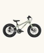 Side of Early Rider kids Seeker 14 inch mountain bike in sage green with a brushed aluminium bottom half frame. Features disk brakes and chunky wheels