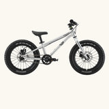 Side of Early Rider kids Seeker 14 inch mountain bike in brushed alloy. Features disk brakes and chunky wheels