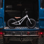 Early rider 12 inch charger balance bike in the back of a blue 4x4 truck