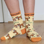 A close up of a child wearing the Eco Kiddies organic cotton cheetah socks showing the cute cheetah design and orange trim detail 