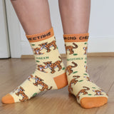 A close up of a child wearing the Eco Kiddies organic cotton cheetah socks showing the cute cheetah design and orange trim detail 
