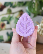 person holding the Ecoliving Soap Free Solid Shampoo Bar with Wild Fig scent in hand
