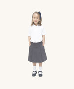 A little girl wearing the Eco Outfitters organic cotton school pleated skirt in grey