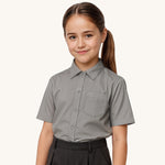 A child wearing a Eco Outfitters Grey coloured Short Sleeves Button-Up School Shirt. The shirt is a part of a wider selection of organic cotton school uniform available at Babipur. 