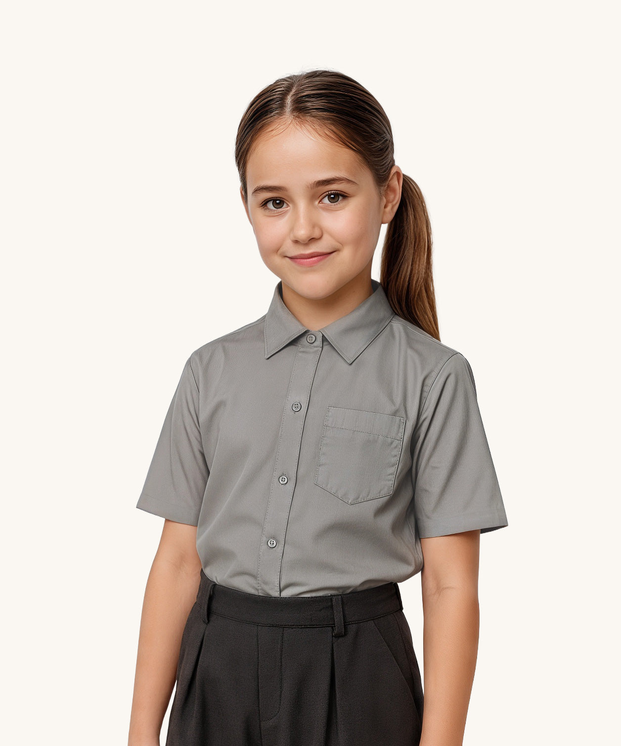 A child wearing a Eco Outfitters Grey coloured Short Sleeves Button-Up School Shirt. The shirt is a part of a wider selection of organic cotton school uniform available at Babipur. 