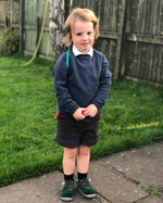 A child wearing an Eco Outfitters organic school jumper in navy.