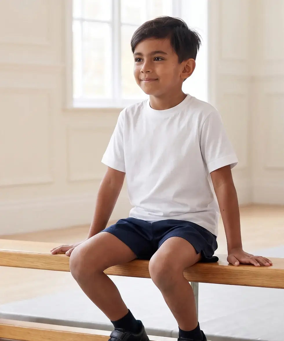 Boy in school PE lesson wearing Eco Outfitters organic cotton white t-shirt and PE shorts. 
